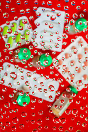 Abstract background with water drops on a glass.Reflection in drops of water of medicines.の写真素材