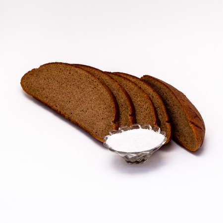 Sliced rye bread with salt on a white background isolate