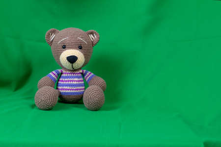 Amigurumi doll teddy bear sitting.の写真素材