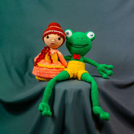 Dolls Amigurumi girl and frog, photo on a gray background.の写真素材