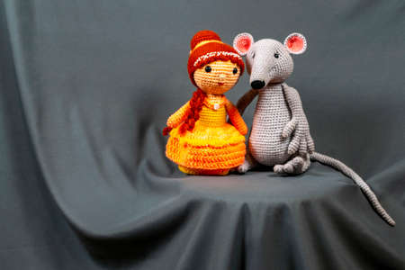 Dolls Amigurumi girl and mouse, photo on a gray background.の写真素材