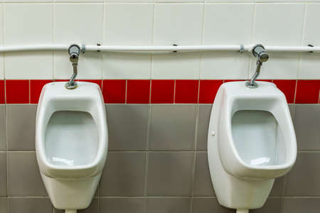White urinals in an empty toilet.の写真素材