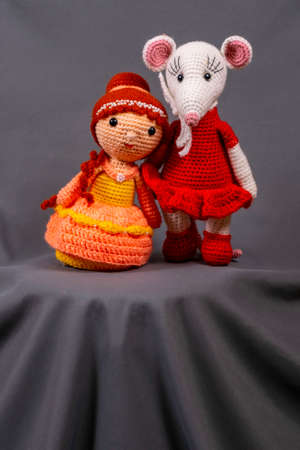 Dolls Amigurumi girl and mouse, photo on a gray background.の写真素材