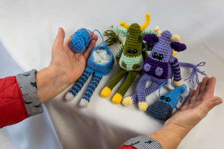 Amigurumi doll in the hands of a woman.の写真素材