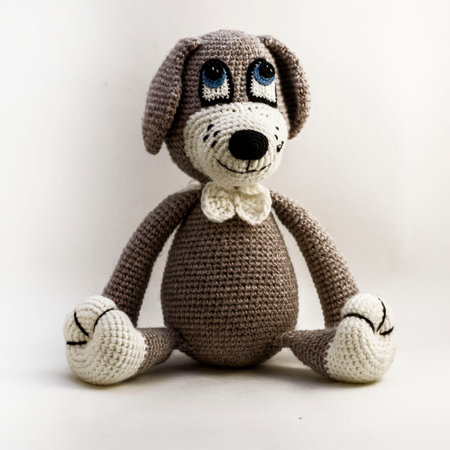 Amigurumi doll gray dog sitting. Isolate.の写真素材