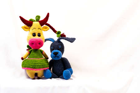Two Amigurumi dolls a cow and a dog. Photo on a white background.の写真素材