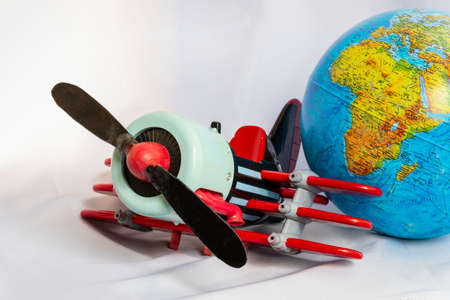 Toy plane and globe on a white background.