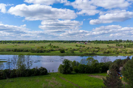 Bird's-eye view: river, fields, village.