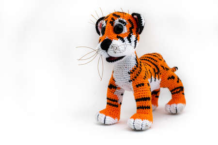 Handmade Amigurumi tiger cub doll is a symbol of 2022. Isolateの写真素材