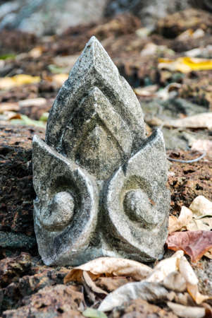 Part of ancient architecture on ground filled with fallen leaves, Sukhothai, Thailand の写真素材