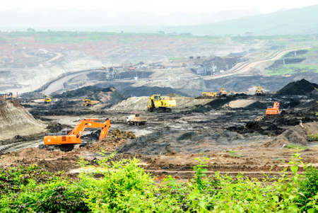 The backhoes and the bulldozer excavates lignite in the coal mine, Mae Moh mine, Lampang, Thailand 
