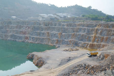 A full-load of limestone is carrying out  by the mining truck and taken to the limestone processing plant.のeditorial素材