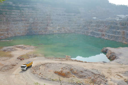 A full-load of limestone is carrying out  by the mining truck and taken to the limestone processing plant.のeditorial素材