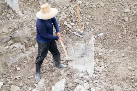 A construction worker cuts a concrete bored pile at pile's cut off level.の写真素材