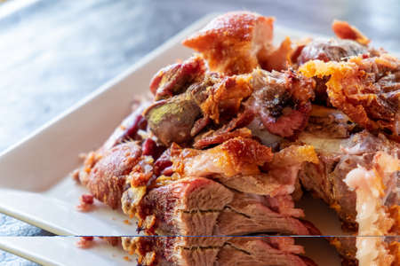 Roasted pork leg on a white dishの写真素材