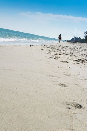 man in speedos walking lamai beach on koh samui in the gulf of thailandの写真素材