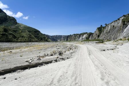 tyre tracks in sand running through crow valley leading to mount pinatubo in pampanga, luzon, the philippinesの写真素材