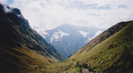 tourists hiking the inca trail overlooking ruined incan city of machu picchu near cusco in peru south americaの写真素材