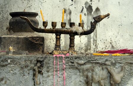 candles and insense at buddhist temple in thailandの写真素材