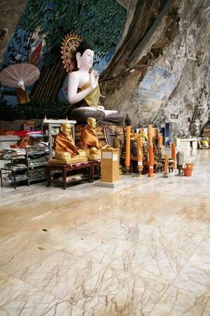 seated buddha in cave temple near krabi thailandの写真素材