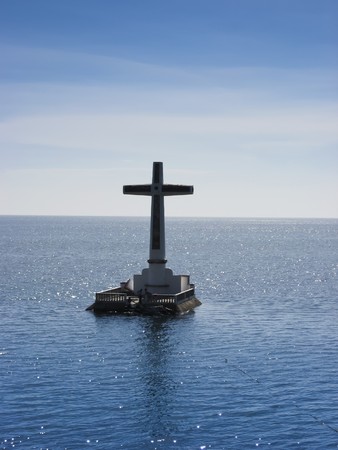 large crucafix marking the underwater sunken cemetary of the coast of camiguin island near mindanao in the philippinesの写真素材