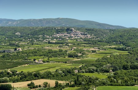 ancient hill town in provence france surrounded by orchards, farms and woodlandの写真素材
