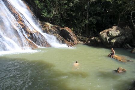 tourists swimming in natural pool of waterfall on koh samui thailandのeditorial素材
