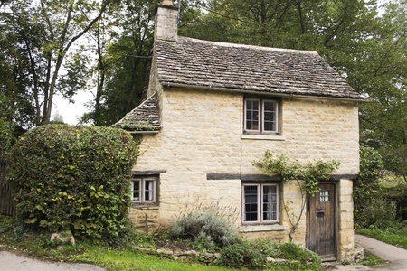 small golden limestonoe cottage in the village of bibury in the cotswalds, gloucestershire, englandのeditorial素材
