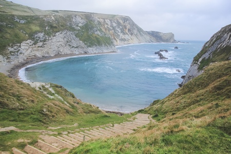 steps leading down steep cliffs to durdle dor beach on dorset coastline lulworth englandの写真素材