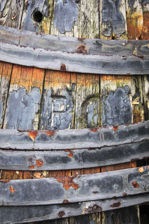 rusting metal hoops on decayed old wooden barrelの写真素材