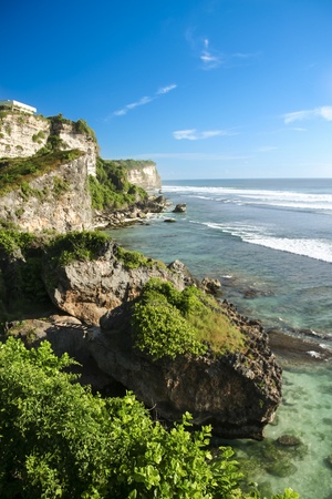 rock coastline of the ulu watu surf break in bali indonesiaの写真素材