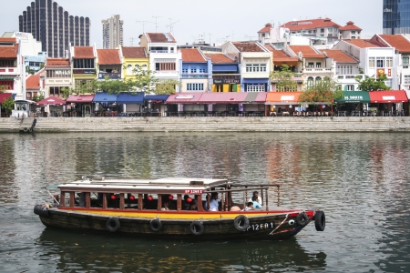 Singapore - May 11, 2008 : Tourist boat passing Clarke Quay.