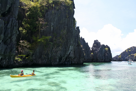 El Nido, Palawan in the Philippines - May 19 2007: tourists kayaking through the costal karst lagoons - EL Nido is ranked as one of the best travel destinations in the world winning many travel awardsのeditorial素材