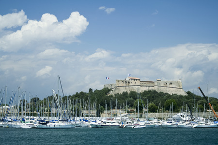 Antibes, France - July 2, 2007: Yachts in the port under Fort Carre. Antibes is a Mediterranean resort in the Alpes-Maritimes department of southeastern France, on the Cote d'Azur between Cannes and Nice.のeditorial素材