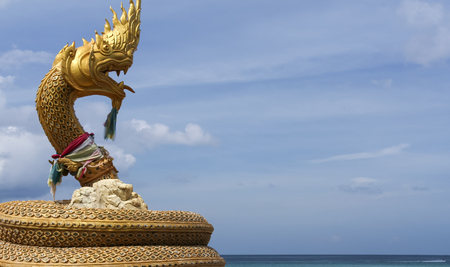 golden naga statue on karon beach phuket thailandの写真素材