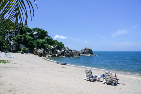 tourist relaxing on sun lounger coral cove beach near lamai on ko samui island in the gulf of thailandの写真素材