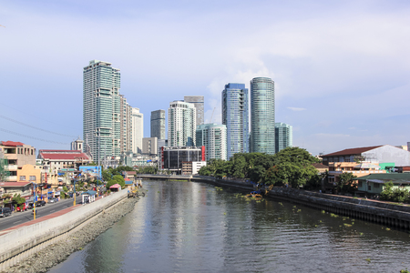 MANILA - JUNE 12: The pasig river in makati passing  by high rise condo buildings of Rockwell distrcit on June 12 2014  in Manila. The 25 kilometre Pasig River connects Laguna de Bay to Manila Bay.のeditorial素材