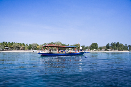outrigger dive boat over dive site off the coast of gili air indoensiaの写真素材