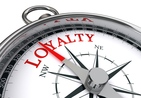 Loyalty word on conceptual compass, isolated on white backgroundの写真素材