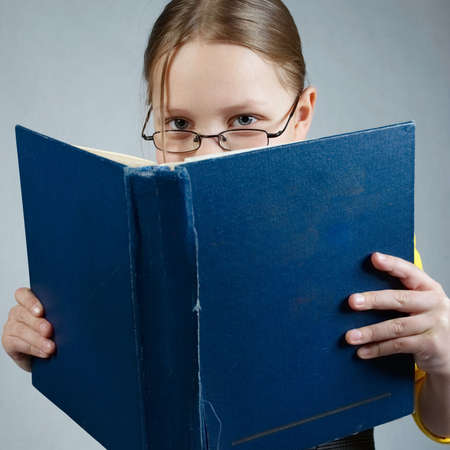 Little pupil  girl with booksの写真素材