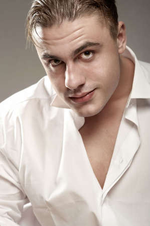 Portrait of young handsome man in white shirtの写真素材