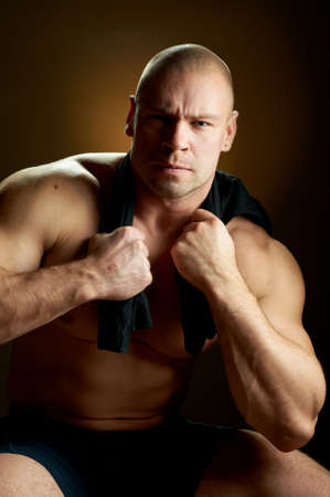 Muscular man, contrasty studio portraitの写真素材