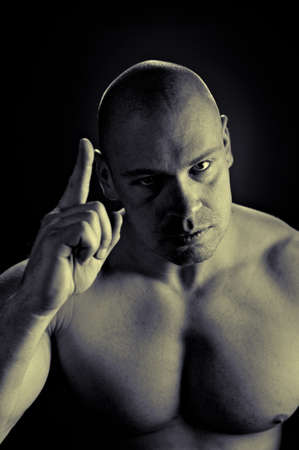 Muscular man, contrasty studio portraitの写真素材