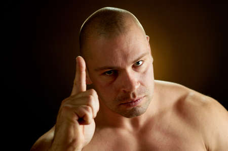 Muscular man, contrasty studio portraitの写真素材