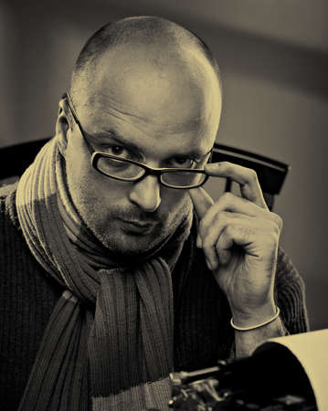 Portrait of a bald serious man in glassesの写真素材