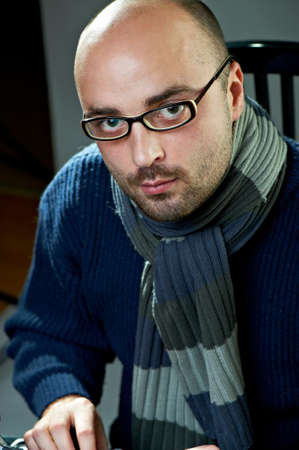 Serious bald man at a typewriter