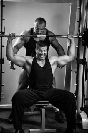 Two strong muscullar mans training body in gym. の写真素材