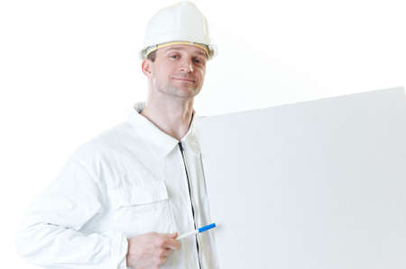 Smiling builder man with blank and pen in hemlet  isolated on whiteの写真素材