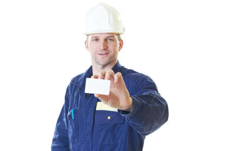 Smiling builder man in blue robe with visit card isolated on white