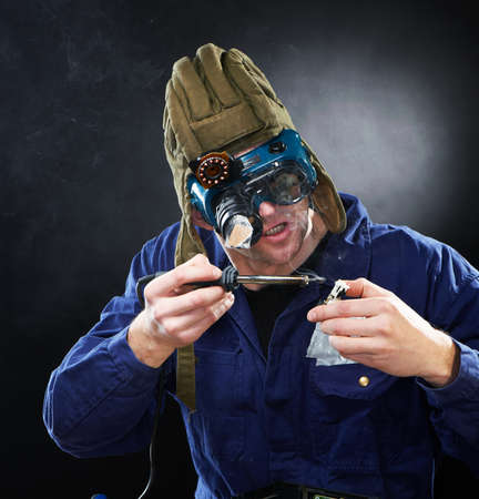 Crazy funny genious with soldering ironの写真素材